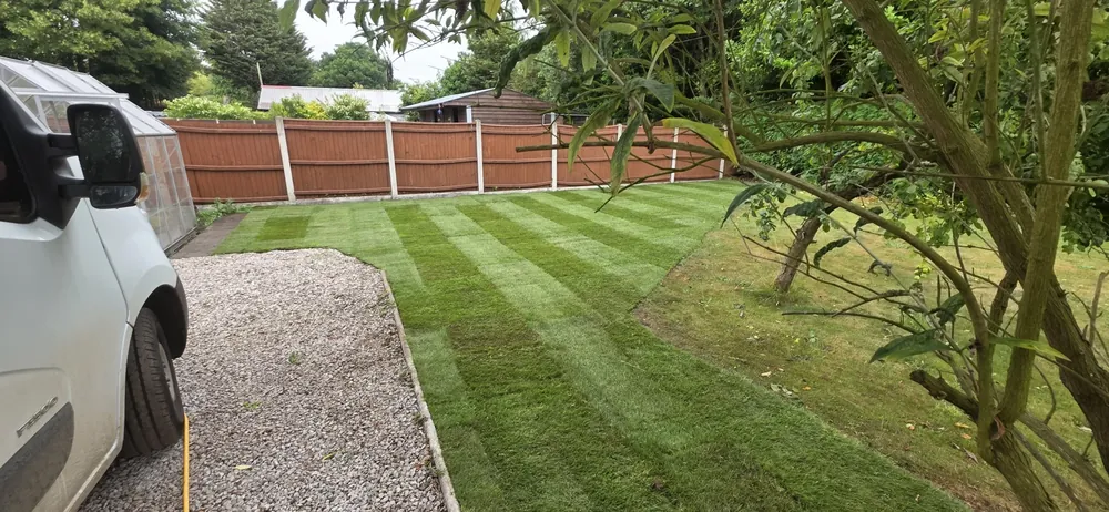 A striped lawn beside a gravel drive in Norfolk